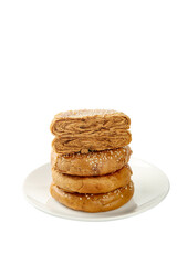 Stack of Golden Flaky Pastries with Sugar Coating on White Plate
