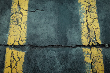 A full frame shot of a grungy asphalt road