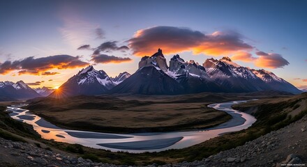 Majestic mountain range landscape with river under dramatic sunset sky