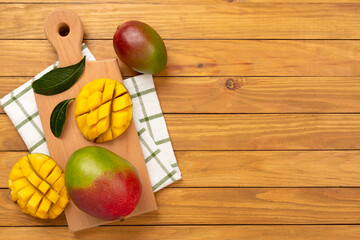 Fresh ripe mango on wooden background, top view