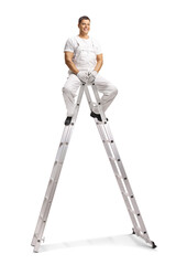 Worker in white overalls sitting on top of a telescopic ladder