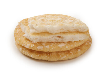 Crispy Rice Crackers Stack with White Coating - Traditional Asian Snack Food on White Background