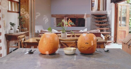 Sitting two carved jack-o'-lanterns glowing on dark island in rustic home, with bowl and knife © vectorfusionart