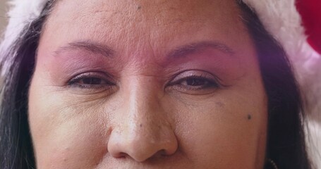 Posing mature woman holding pose in studio close-up, showing white fur hat, earring, makeup, mole