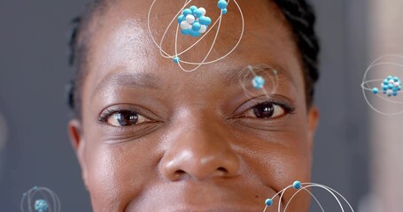 Showing African American woman with braids revealing skin texture in studio, with molecular orbits