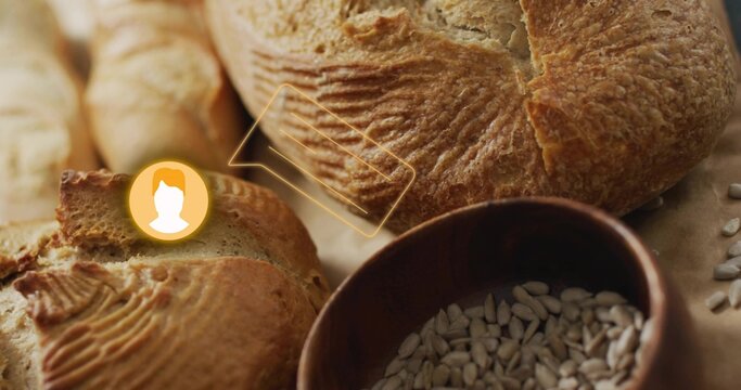 Fototapeta Showing crusty artisan loaf on counter, with sliced baguette, bowl of sunflower seeds, UI overlay