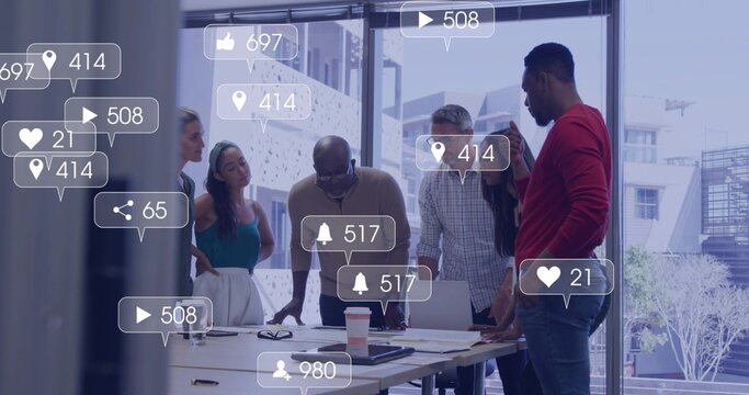 Leaning team of six staff reviewing layouts at office table, in business attire with social icons - Powered by Adobe