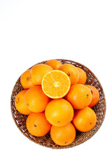 Fresh Sweet Navel Oranges in Wicker Basket Isolated on White Background