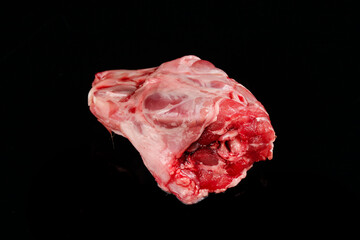 Obraz premium Fresh Raw Rabbit Head Meat Cut on Black Background - Butcher Shop Ingredient