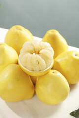 Fresh Yellow Pomelo Citrus Fruits with Peeled Segments on White Background
