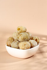 Golden Dried Dates in White Bowl on Beige Background - Healthy Organic Fruit Snack