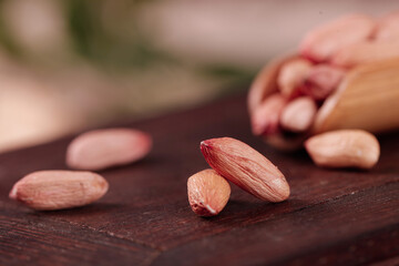 Raw Peanuts with Red Skin on Wooden Table - Healthy Nuts Snack and Cooking Ingredient