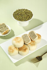 Traditional Mung Bean Cakes Asian Dessert with Green Bean Filling and Raw Beans
