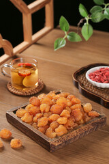 Traditional Dried Fruits and Herbal Tea - Healthy Snacks with Goji Berries and Golden Raisins on Rustic Wood Table