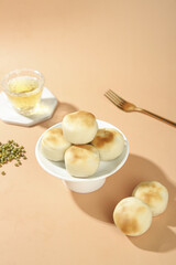 Traditional Mung Bean Cakes Asian Confectionery Dessert Display with Tea and Gold Fork Old-Fashioned Sweet Treats
