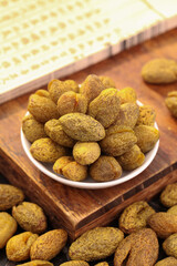 Chaoshan Candied Licorice Olives - Traditional Chinese Dried Fruit Snack in Bowl on Wooden Tray