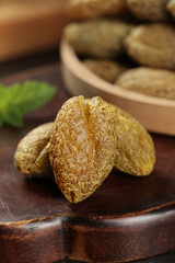 Chaoshan Dried Fruits Preserves with Licorice Flavor and Olives on Wooden Board