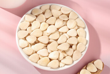 Peeled Sliced Sweet Almonds in White Bowl on Pink Background - Healthy Nuts Ingredient Food Photography