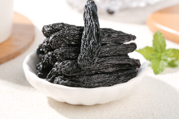Xinjiang Black Raisins in White Bowl with Mint Garnish - Premium Dried Fruit Display