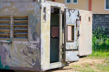 Weathered Metal Storage Container Unit with Open Door and Peeling Camouflage Paint