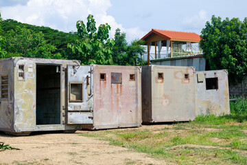 Construction Workers Dismantling and Recycling Old Container Panels Outdoors