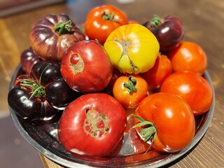 a tray of colorful tomatoes, yellow tomatoes, black tomatoes, home-grown garden produce