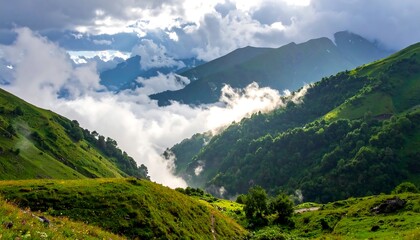 Green mountainsides covered in lush grass, with clouds nestled amongst peaks in a daytime panoramic view