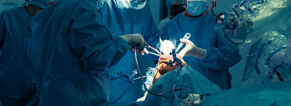 In a sterile operating room, surgeons employ the robotical surgery knee system to perform a total knee arthroplasty. Robotic assistance enhances precision and personalization