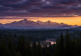 Obraz premium Mountains glow during sunset over evergreen forest landscape