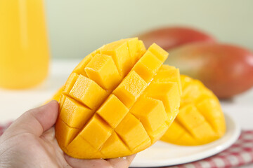 Fresh Ripe Mango Cubes in Hand - Tropical Fruit Ready to Eat