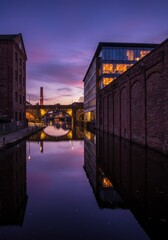 Canal Reflects Buildings at Dusk in Urban Cityscape
