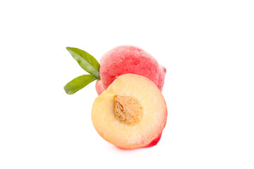 Fresh Summer Peach Cut in Half with Green Leaves on White Background
