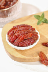 Turpan Xinjiang Red Raisins in Bowl on Wood Board with Mint - Premium Dried Fruit from China