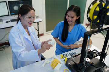 Researchers are working with a 3D printer to print clear, white plastic models using cutting-edge, focused technology in the lab.