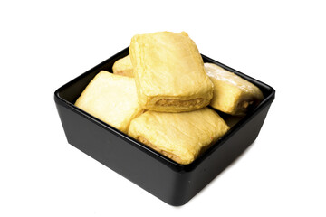 Golden Puff Pastry Squares in Black Ceramic Bowl - Delicious Baked Appetizers and Snacks