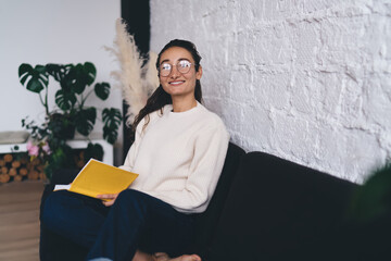 Freelancer smiles holding notebook to chest, embracing inspiration and preparing to translate...