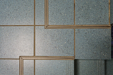 Blue tiled floor with visible expansion joints and metal edge profiles