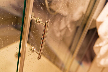 Clear shower door with fresh water droplets after use