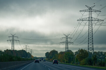 German Highway Autobahn with cars and Nordlink power pylons lining both sides