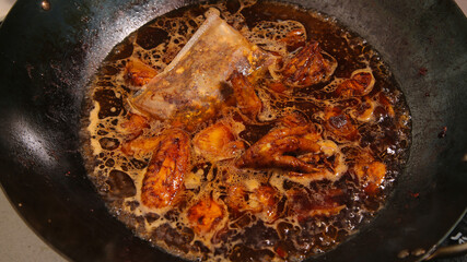 Braised Chicken Nuggets with Caramelized Onions Cooking in Pan