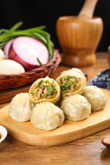Delicious Scallion Meat Dumplings on Wooden Board - Traditional Asian Breakfast Buns and Savory Treats
