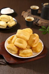 Traditional Chinese Crispy Doughnuts Breakfast Treats with Tea on Wooden Table