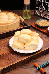 Traditional Chinese Steamed Buns Breakfast with Bamboo Steamer and Chopsticks on Wooden Table