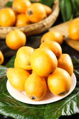 Fresh Sweet Loquat Fruits from Panzhihua Alpine Region Displayed on White Plate with Wicker Basket