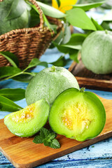 Fresh Emerald Green Melon Slices from Shandong on Wooden Board with White Rustic Background