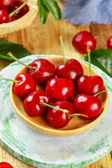 Fresh Red Cherries in Wooden Bowl on Rustic Kitchen Table