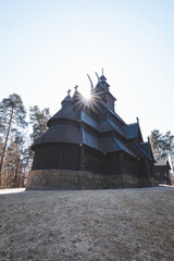 Morning sunlight shines through the towers of Gol Stave Church in Oslo, Norway, revealing the intricate wooden design of ancient Nordic architecture