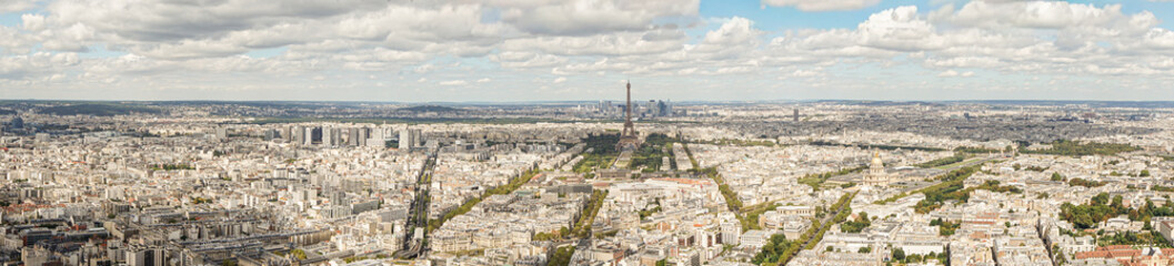 Obraz premium A panoramic view of the city of Paris in France, taken from the top of the Montparnasse skyscraper The Eiffel Tower and many other landmarks are visible. The sky is blue and cloudy