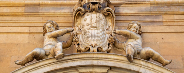 Decorated stone pediment with coat of arms