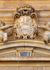 Decorated stone pediment with coat of arms